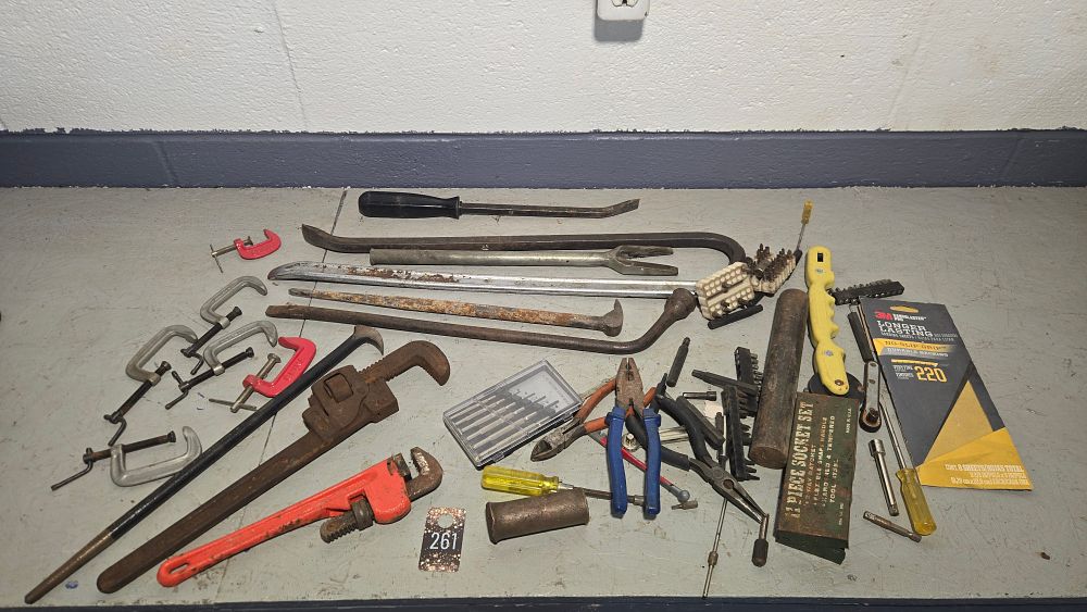 Lot 261: tote with tire iron, crowbar, pipe wrenches, clamps and more