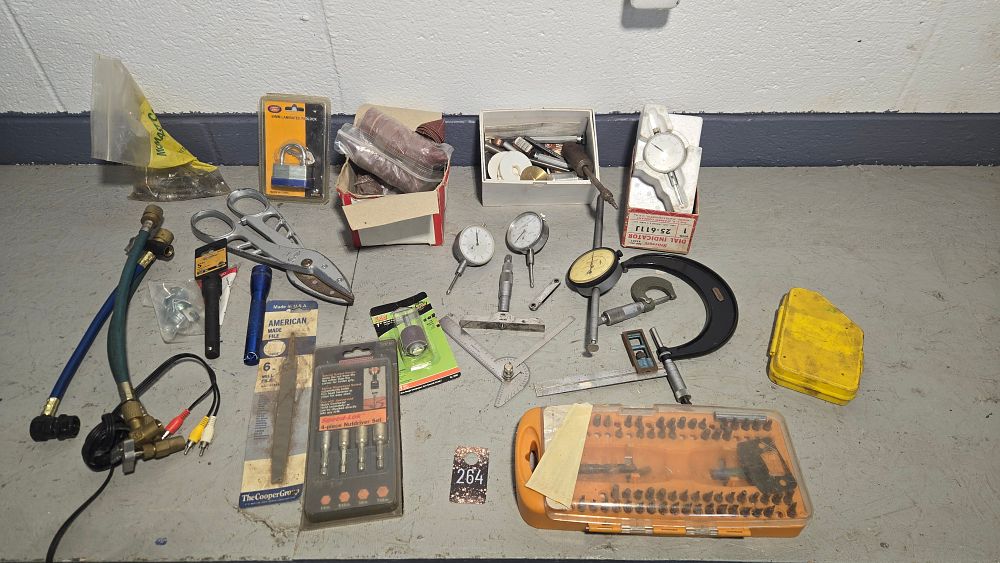 Lot 264: Blue tote with bit sets, tin snips, new padlock, Starrett dial indicators and other measuring devices.