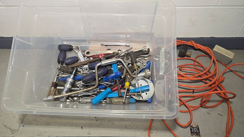 Lot 265: Clear tote of tools and 2 extension cords