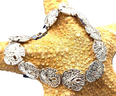 Sterling Silver Sand Dollar Link Bracelet 7.25". STERLING SILVER .925 
7.25" LONG 
3/4" WIDE 