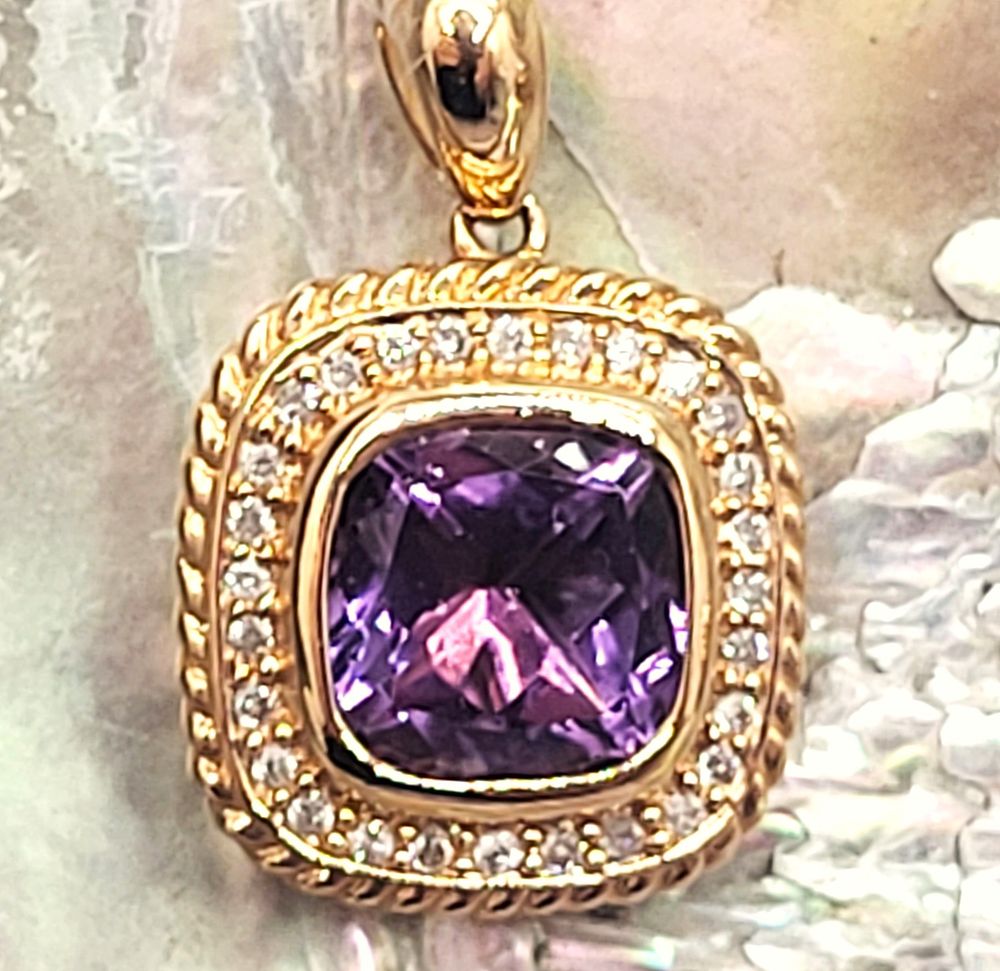 Brazilian Amethyst and Diamond Halo Pendant. Setting: 14K Yellow Gold 
Main Gemstone: 