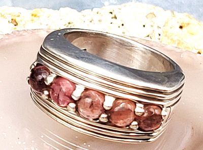 Signed BADAVICI Rhodolite Band. Setting: Sterling Silver .925
Main Gemstone: Genuine