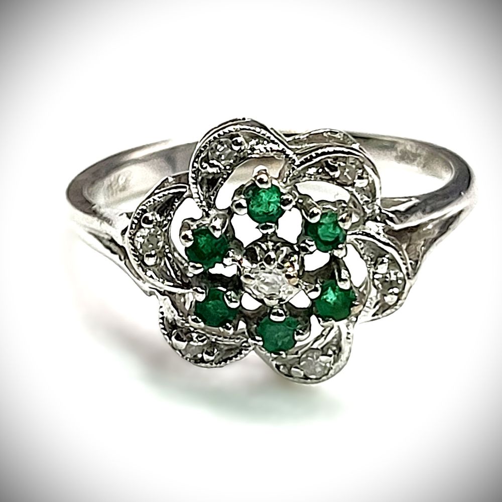 Emerald Cluster Ring with Diamond Swirl Halo. Setting: 10K White Gold 
Main Gemstone: 