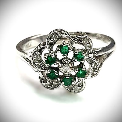 Emerald Cluster Ring with Diamond Swirl Halo. Setting: 10K White Gold 
Main Gemstone: 