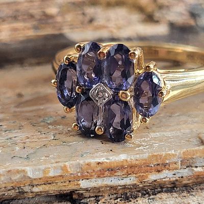 Intriguing Iolite and Diamond Center Flower Ring. 14100001 
Setting: 14K Yellow Gold 
Primary 