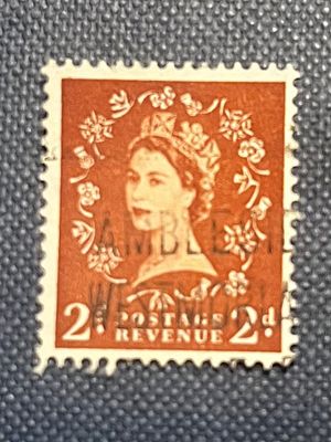 Great Britain Queen Elizabeth II 2d Postage Stamp. A reddish-brown postage stamp featuring a 