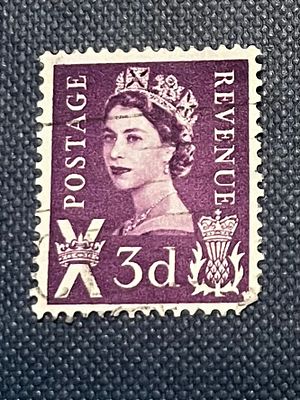 A Queen Elizabeth II Scotland 3d Postage Revenue Stamp. A purple and pink postage and revenue 