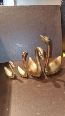 Set of brass swans . 4 brass swans in different sizes