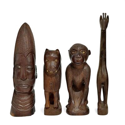 AFRICAN HANDICRAFTS. Set composed of 4 statuettes carved in wood. Dim: 27 cm (largest).