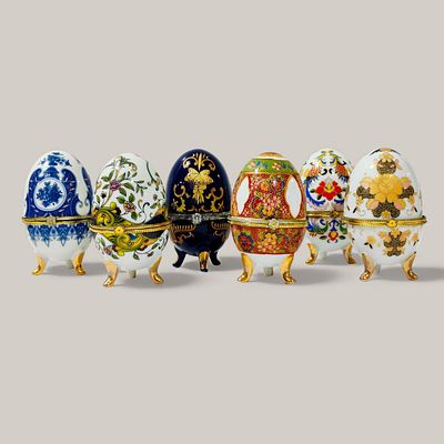 EUROPEAN PORCELAIN. SIX PORCELAIN EGGS - set of six porcelain boxes with hinged lids on gilt 