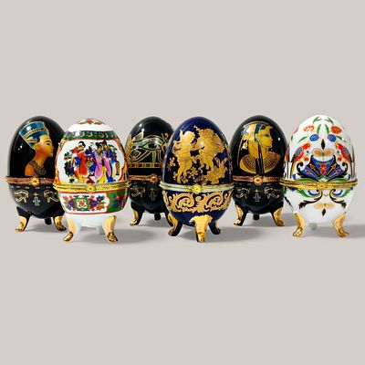 EUROPEAN PORCELAIN. SIX PORCELAIN EGGS - set of six porcelain boxes with hinged lids on gilt 