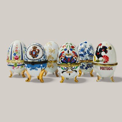 EUROPEAN PORCELAIN. SIX PORCELAIN EGGS - set of six porcelain boxes with hinged lids on gilt 