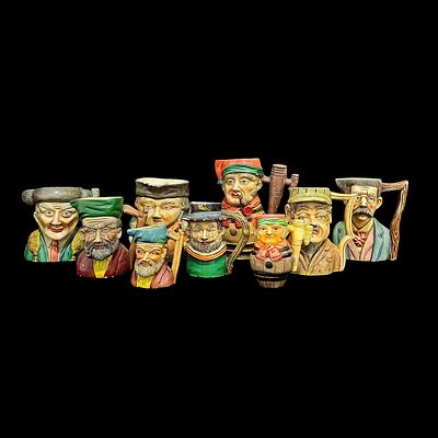 BEER MUGS. Set of 9 faience mugs, various figure decoration. Dim: 21x10 cm.