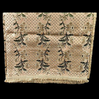 SILK BEDSPREAD. Green tones on a golden background, geometric and floral pattern, fringed trim. 