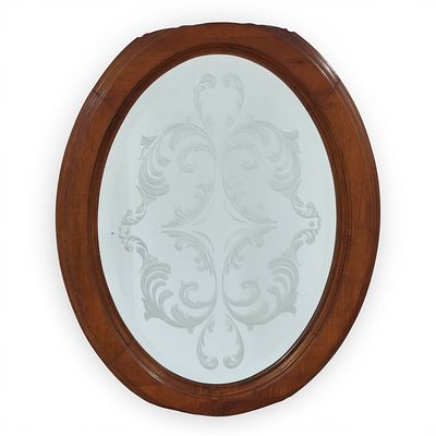 WALL MIRROR. Oval mirror with wooden frame, Mirror with design of plant elements represented in 