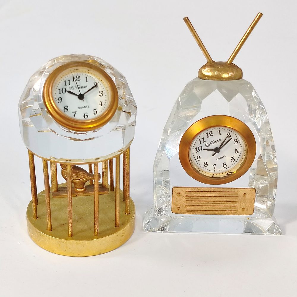 TABLE CLOCKS. Set of 2 table clocks in cut crystal and gilded metal, one in the shape of an old 
