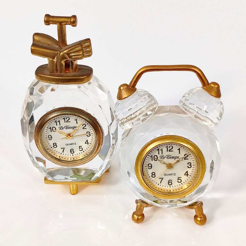 DESK CLOCKS. Set of 2 desk clocks in cut crystal and gilded metal, one in the shape of an alarm 