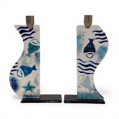 CAST GLASS CANDLE HOLDERS. Cast glass candle holders with a marine-themed design, featuring 