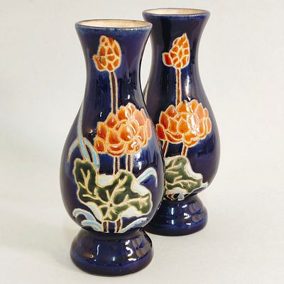 PAIR OF STONEWARE JARS. Pair of blue glazed stoneware jars with floral motifs. Dimensions: 15cm 