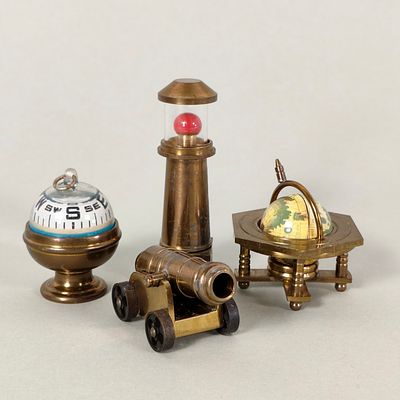 COLLECTIBLE SOLID BRASS NAUTICAL MINIATURES. Includes a globe, cannon, compass, and lighthouse. 