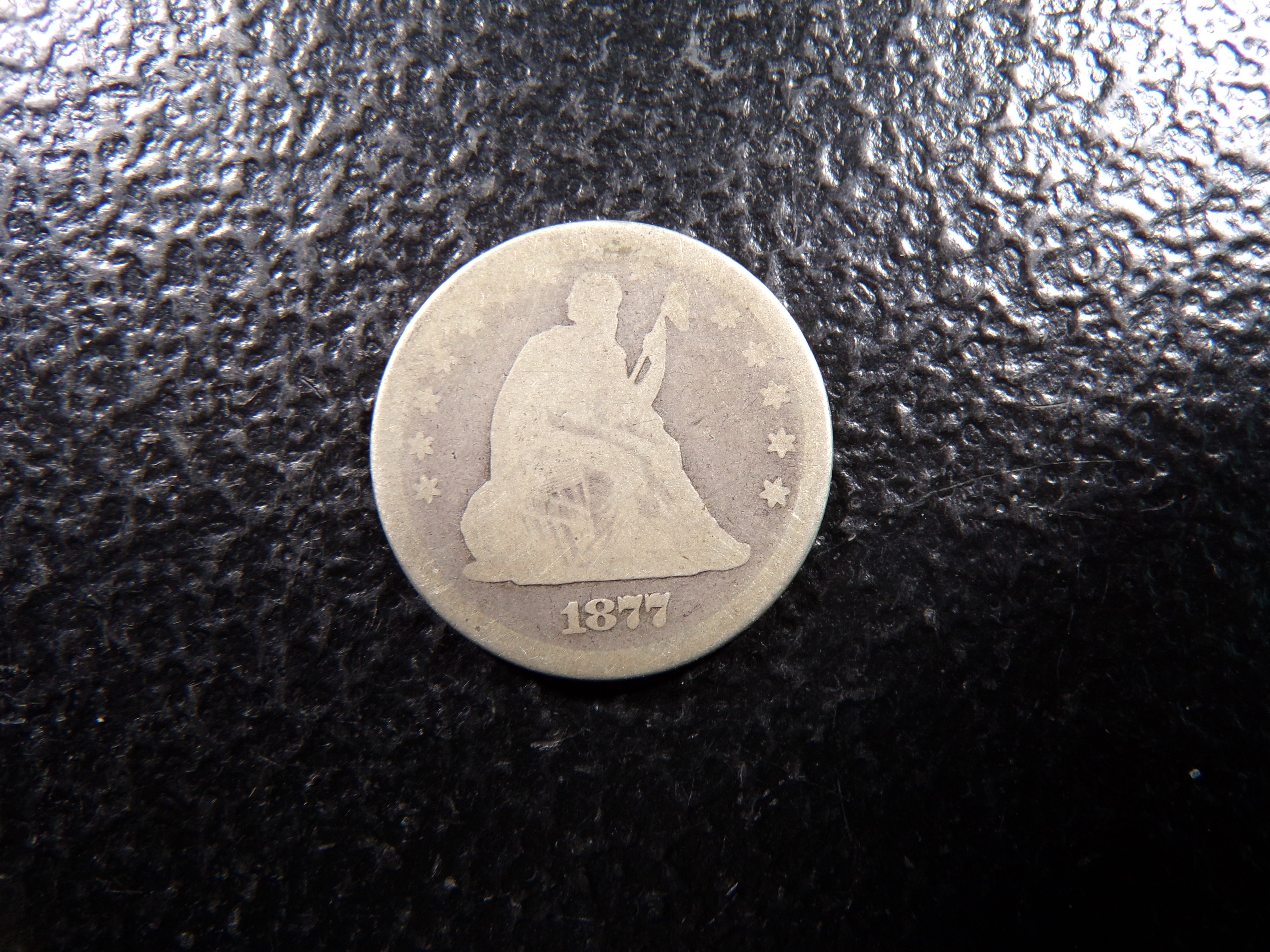 1877 SEATED LIBERTY SILVER QUARTER