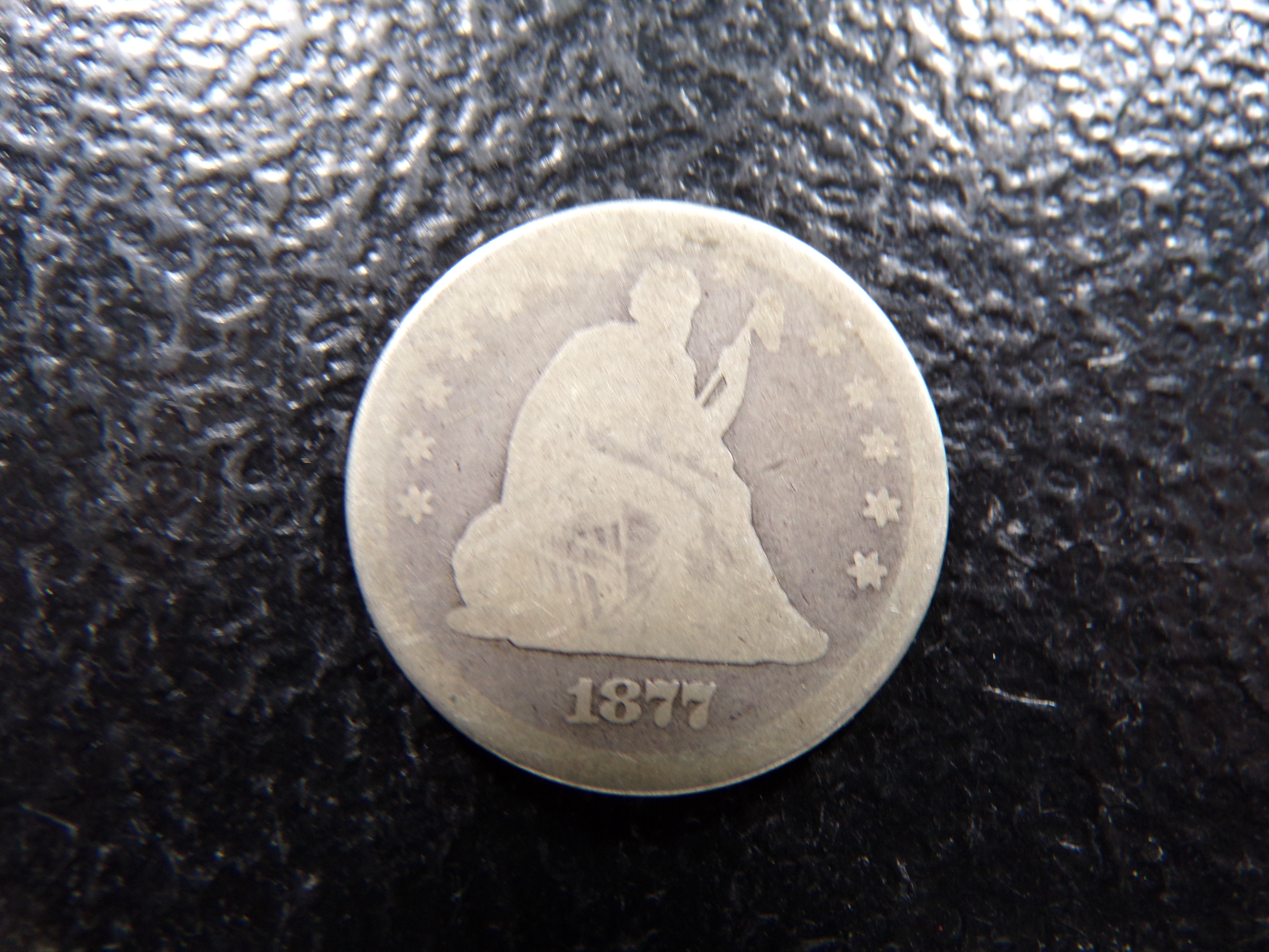 1877 SEATED LIBERTY SILVER QUARTER