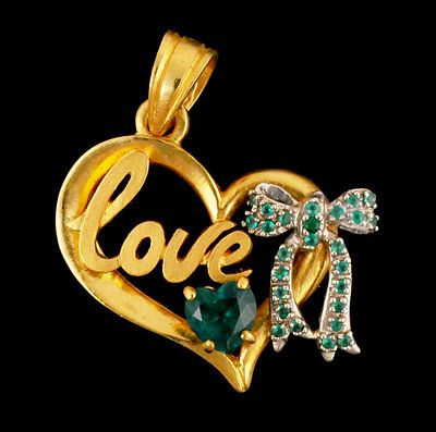 24K Gold Love Pendant. 24 karat yellow and white gold heart and bow pendant with the word "Love"