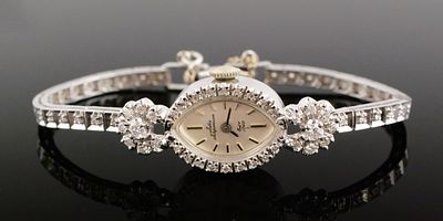 14K Gold Diamond Jules Jurgensen Watch. 14 karat white gold watch set with diamonds around the 