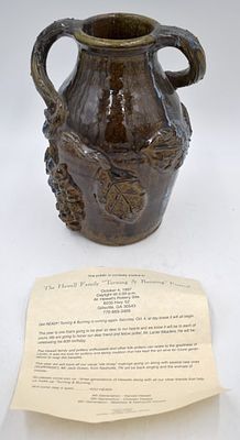 Grace Nell Hewell Folk Art Pottery Storage Jug. Grapevine motif, 10 inches by 6.75 inches 