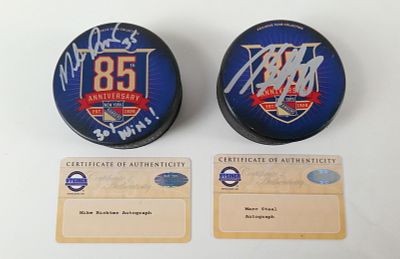 Lot of 2 New York Rangers Signed 85th Anniversary Hockey Pucks. Including Marc Staal with 
