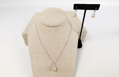 Faux Pearl Necklace and Earrings Set by Nolan Miller. The lot includes a silver tone necklace 