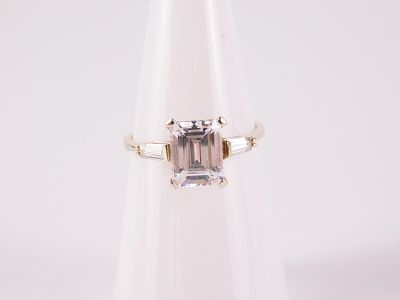 14k White Gold Engagement Ring. Has an 8.4 x 6.5 mm clear emerald cut gemstone with 2 baguette 