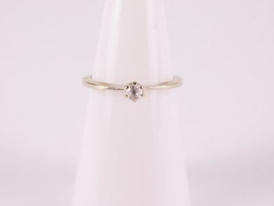 14k White Gold Solitaire Ring. Has a 3.3. mm white gemstone as the center stone. Size 6. All 