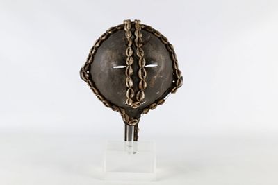 Vintage African Metal, Leather and Cowrie Shell Ceremonial Mask with acrylic display stand. 