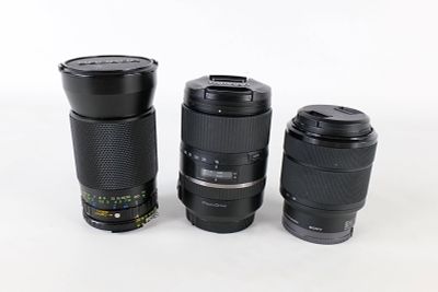 Lot of Three Zoom Lenses. Collection of three zoom lenses by Sony, Tamron, and Soligor featuring 