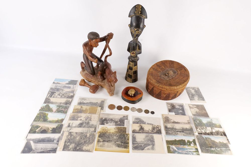 Lot 303: An Assortment of African Wood Carvings, a Woven Basket, U.S. Coins, Medals, and New Jersey Postcards