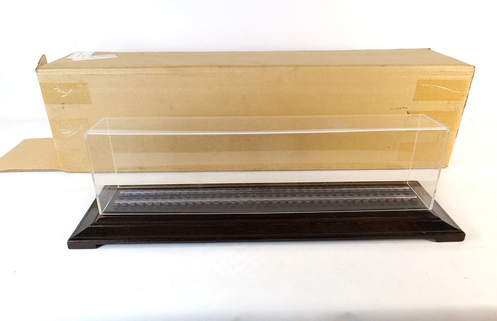 Lot 492: Lucite 0 Train Display case on a wooden base