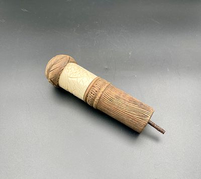 Carved wooden walking stick handle, incorporating carved organic material, with a metal 