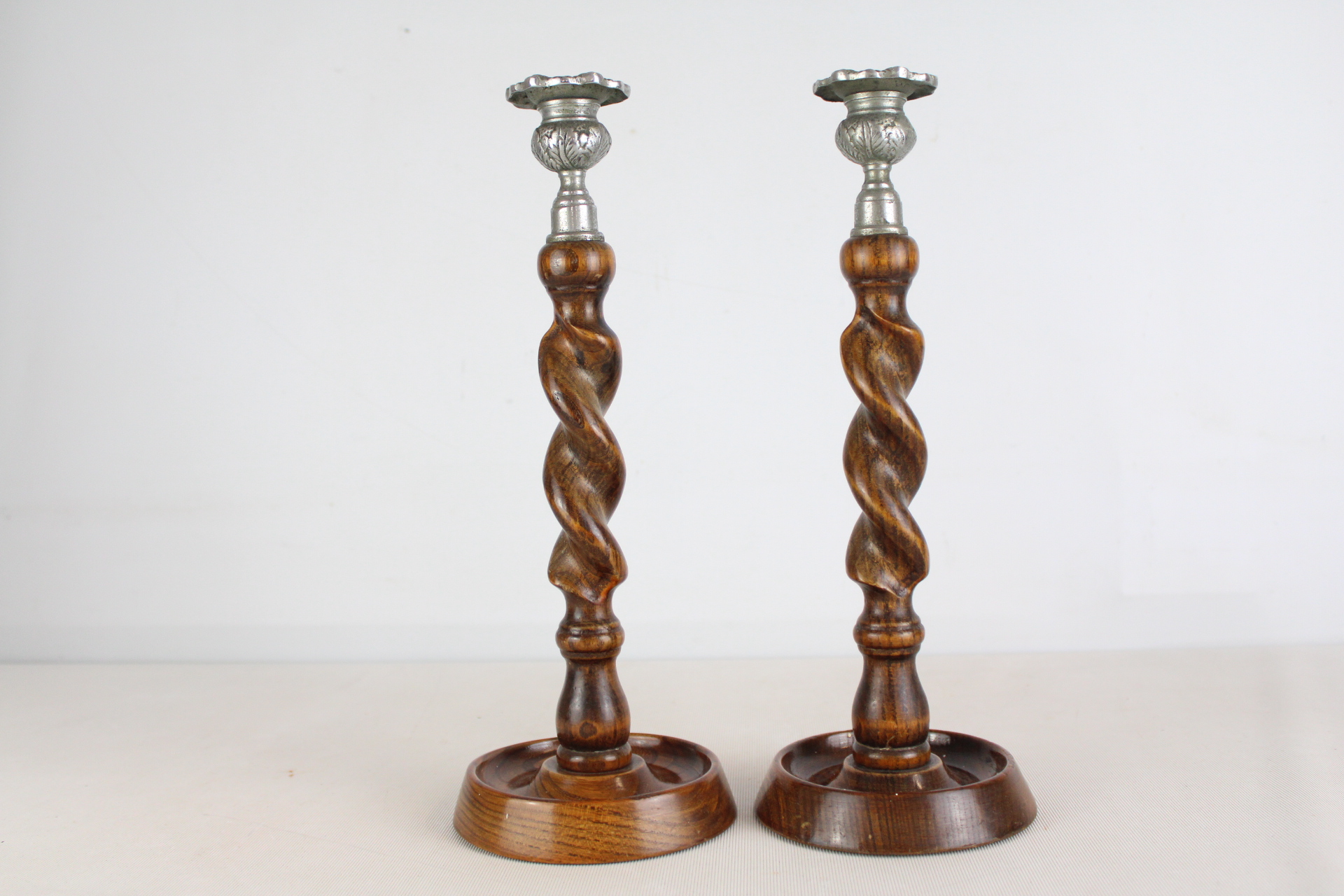 A Pair of English Oak and Silver-Toned Metal Barley Twist Candlesticks