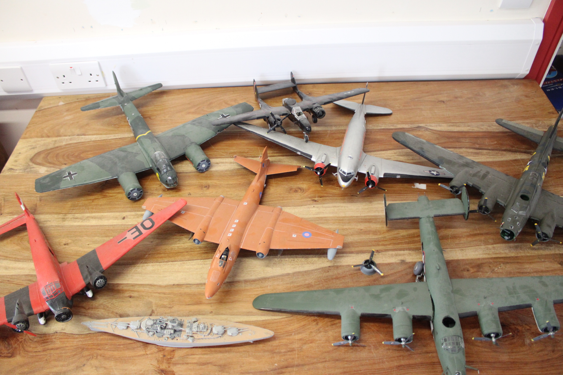 A Collection of Assembled Plastic Scale Model Military Aircraft and a Battleship