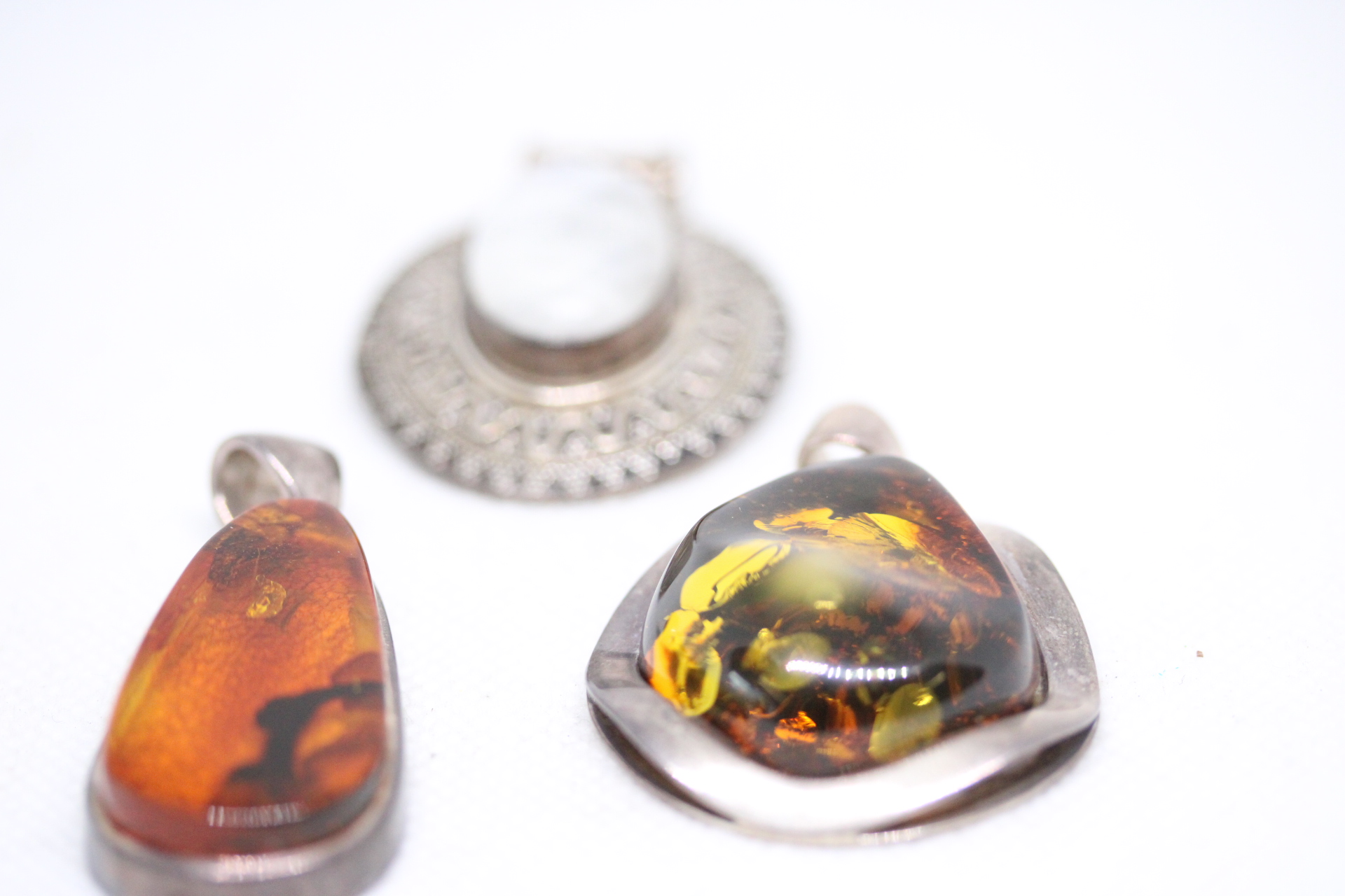 Collection of silver pendants - 1 set with hardstone, 2x set with possible amber