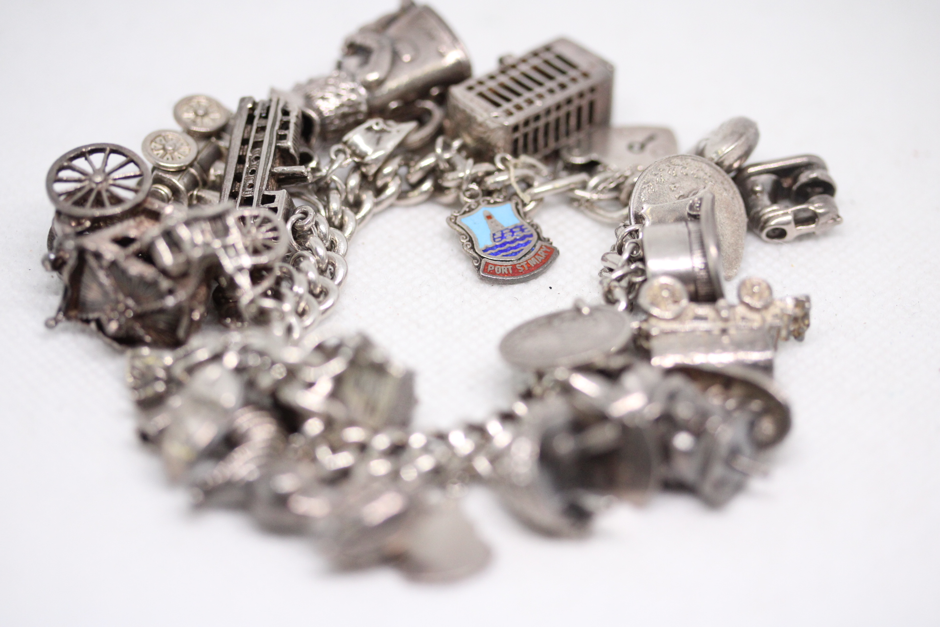Heavy silver charm bracelet with multiple charms Weight 124g