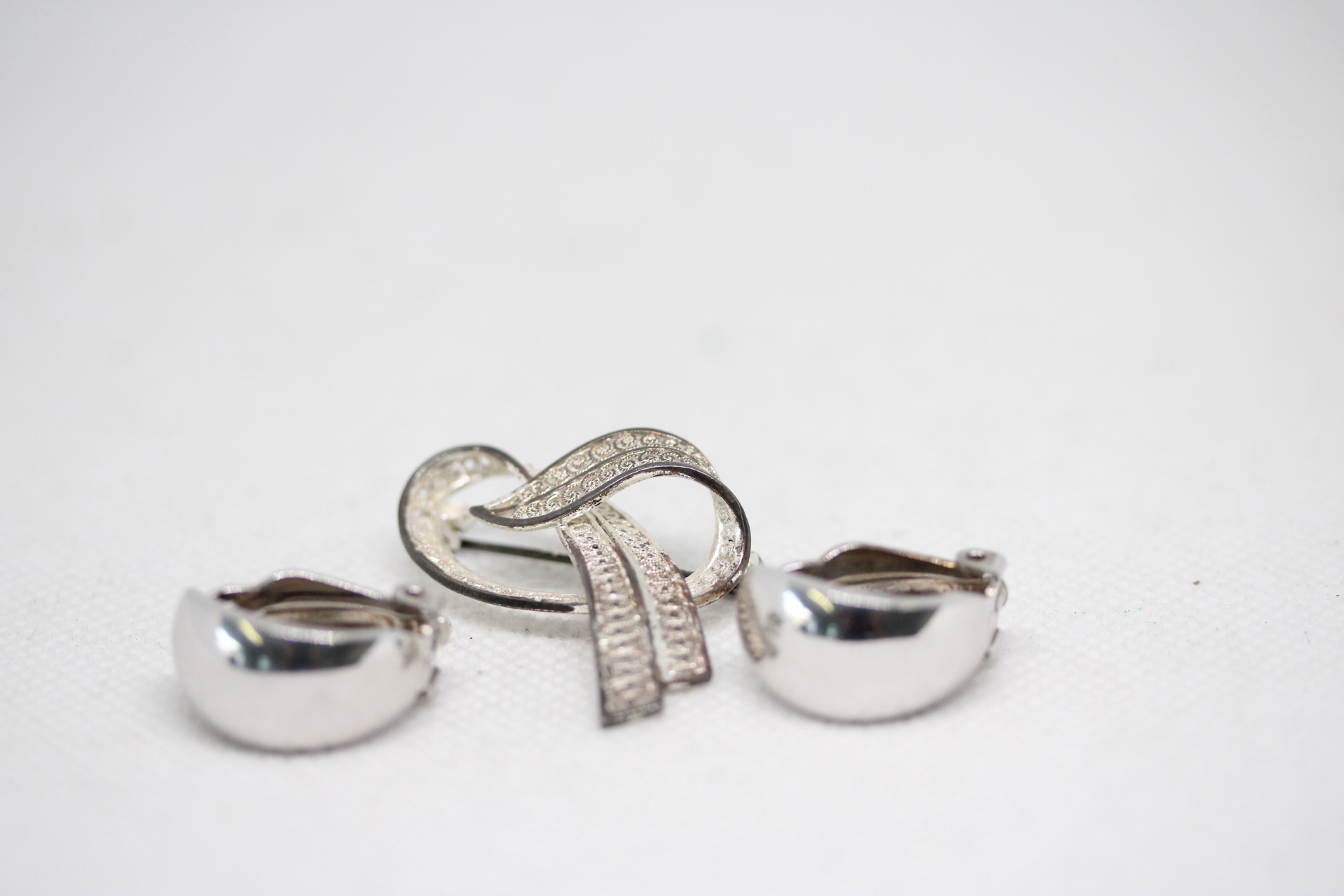 Silver pin brooch together with a pair of silver earrings