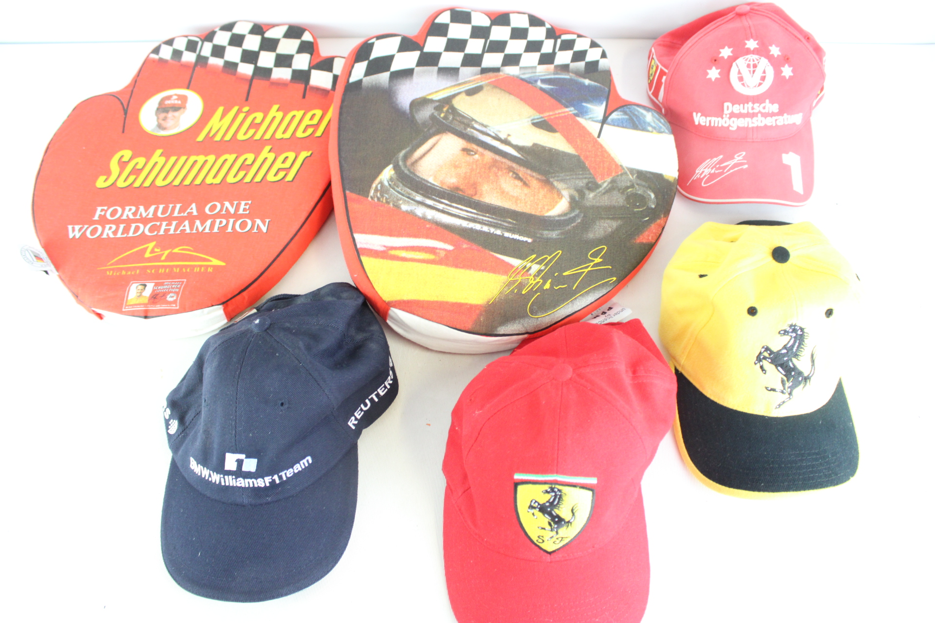 A Collection of Six Michael Schumacher and Formula One Racing Memorabilia Items including Ferrari and BMW Williams F1 Team Caps
