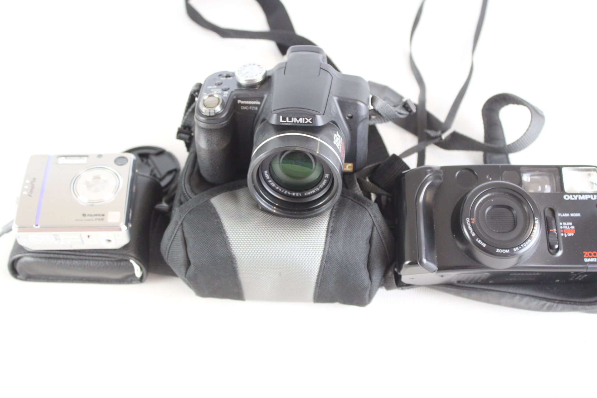 A Trio of Vintage Digital and Film Cameras Including Panasonic Lumix, Fujifilm FinePix, and Olympus Models
