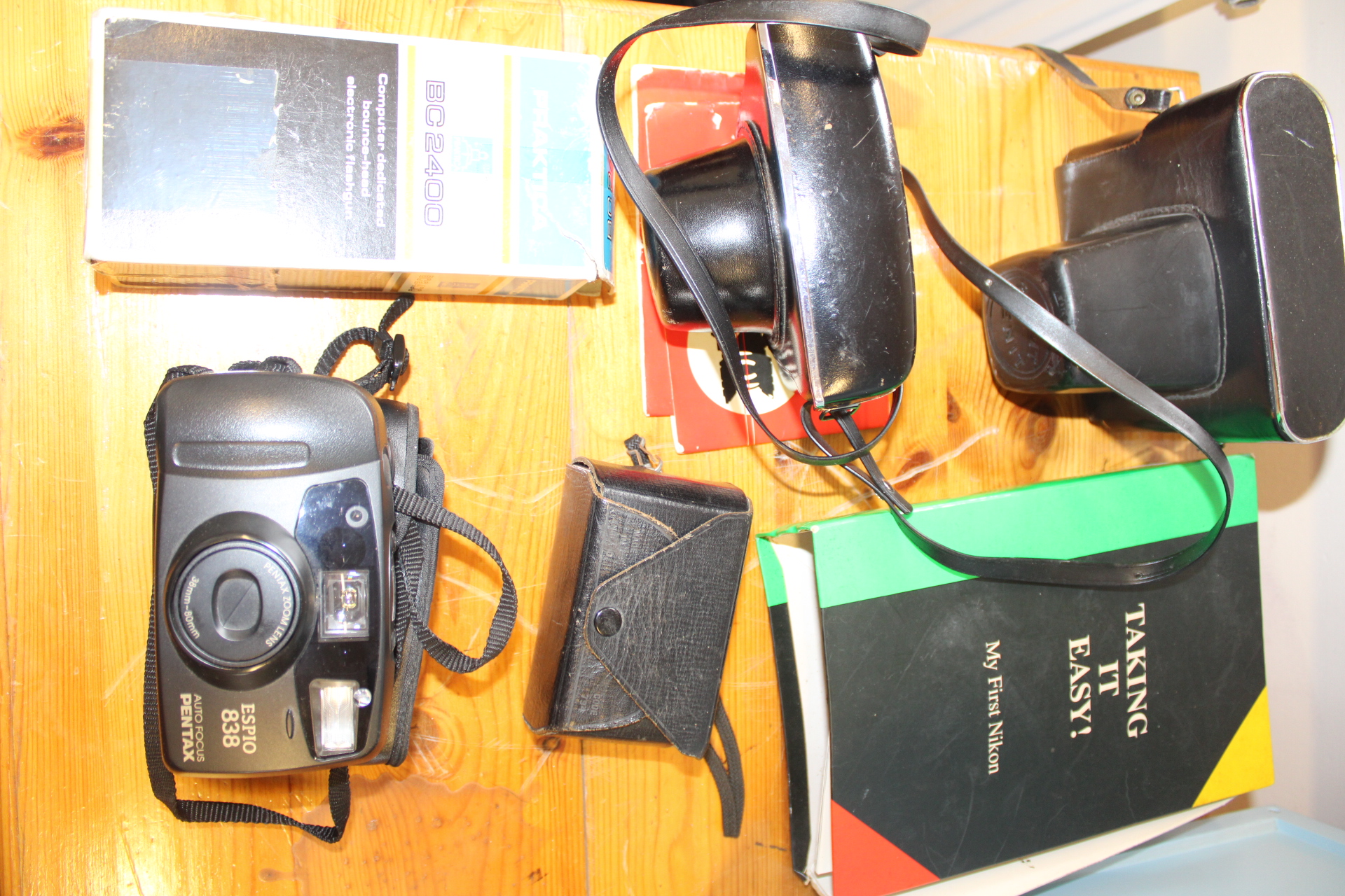 A Collection of 35mm Film Cameras and Photographic Equipment Including Pentax and Praktica