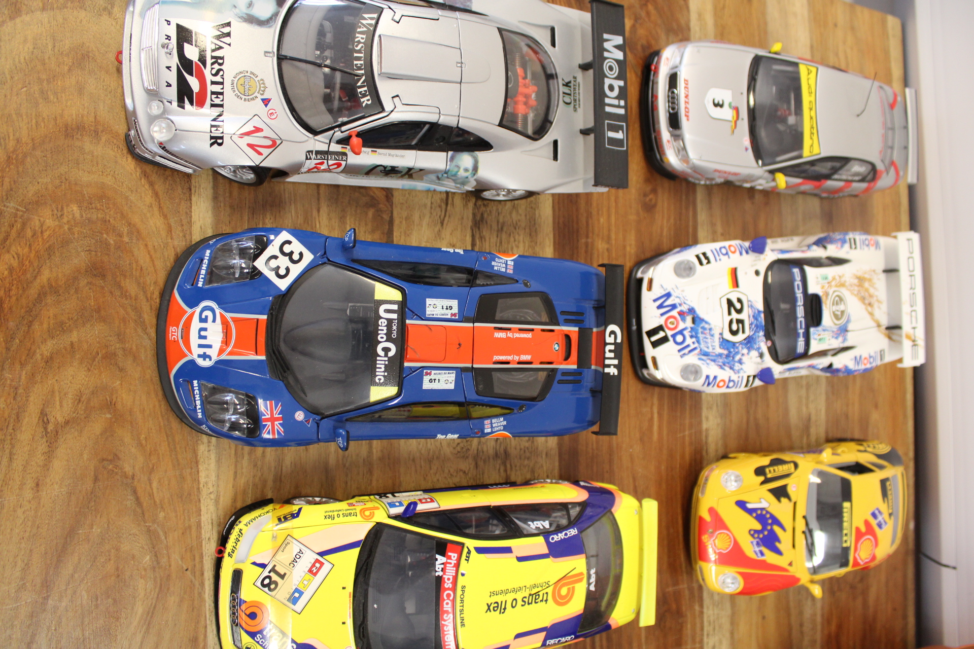 A Collection of Six 1/18 Scale Die-Cast Model Racing Cars by UT Models, Minichamps, and Maisto