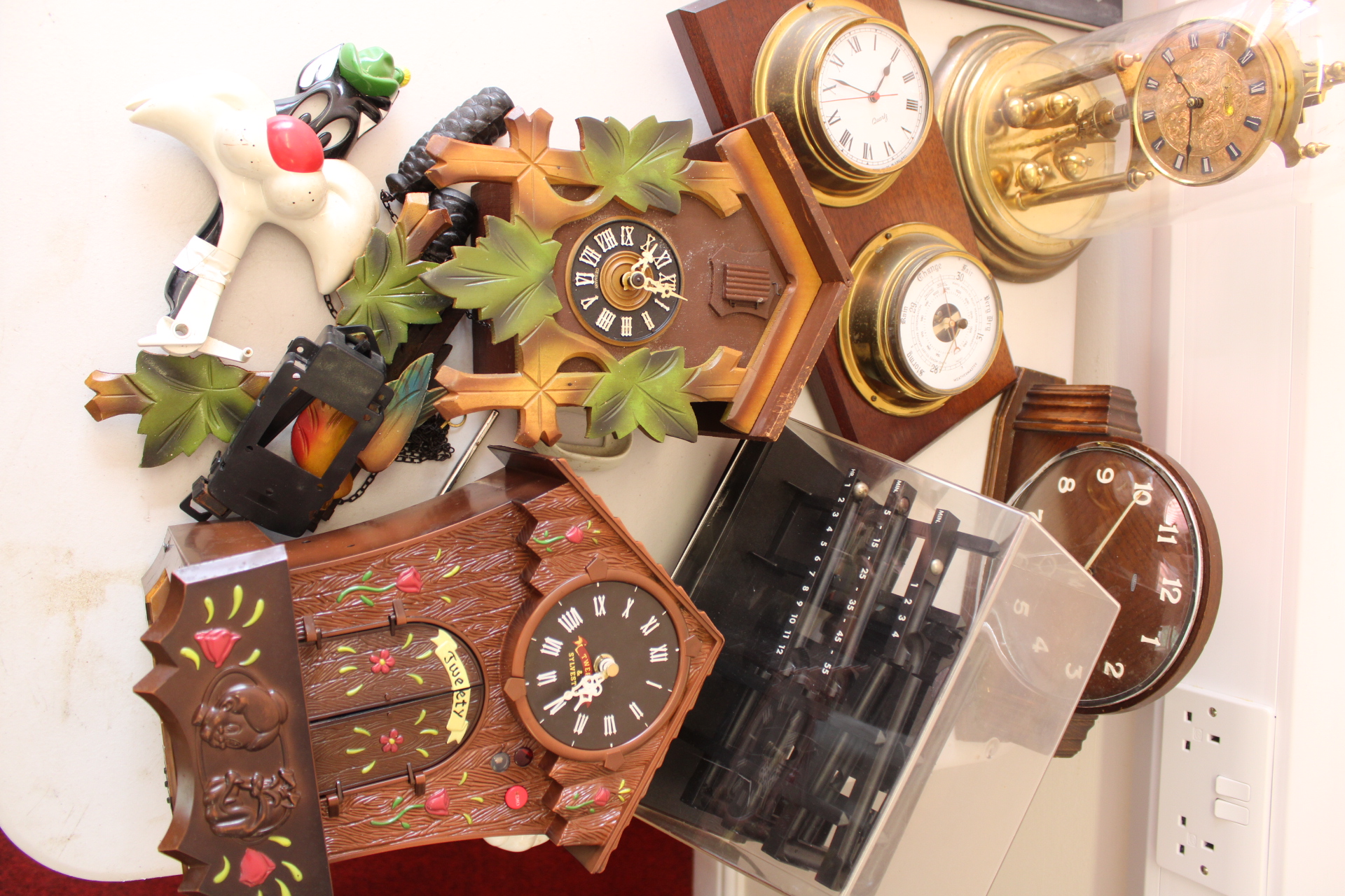 An Assortment of Seven Clocks and Timekeeping Instruments Including Novelty and Traditional Styles