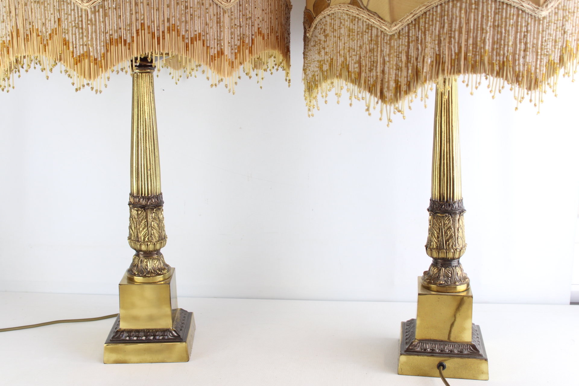 A Pair of Neoclassical Style Brass Table Lamps with Beaded Fringe Shades