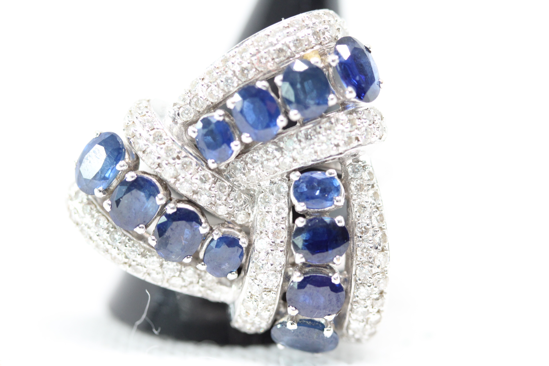 Large & impressive 18ct White gold ring set with diamonds & sapphires. 12 sapphires approx. 1/2 carat each surrounded by diamond clusters. Total weight 21.8g Size T